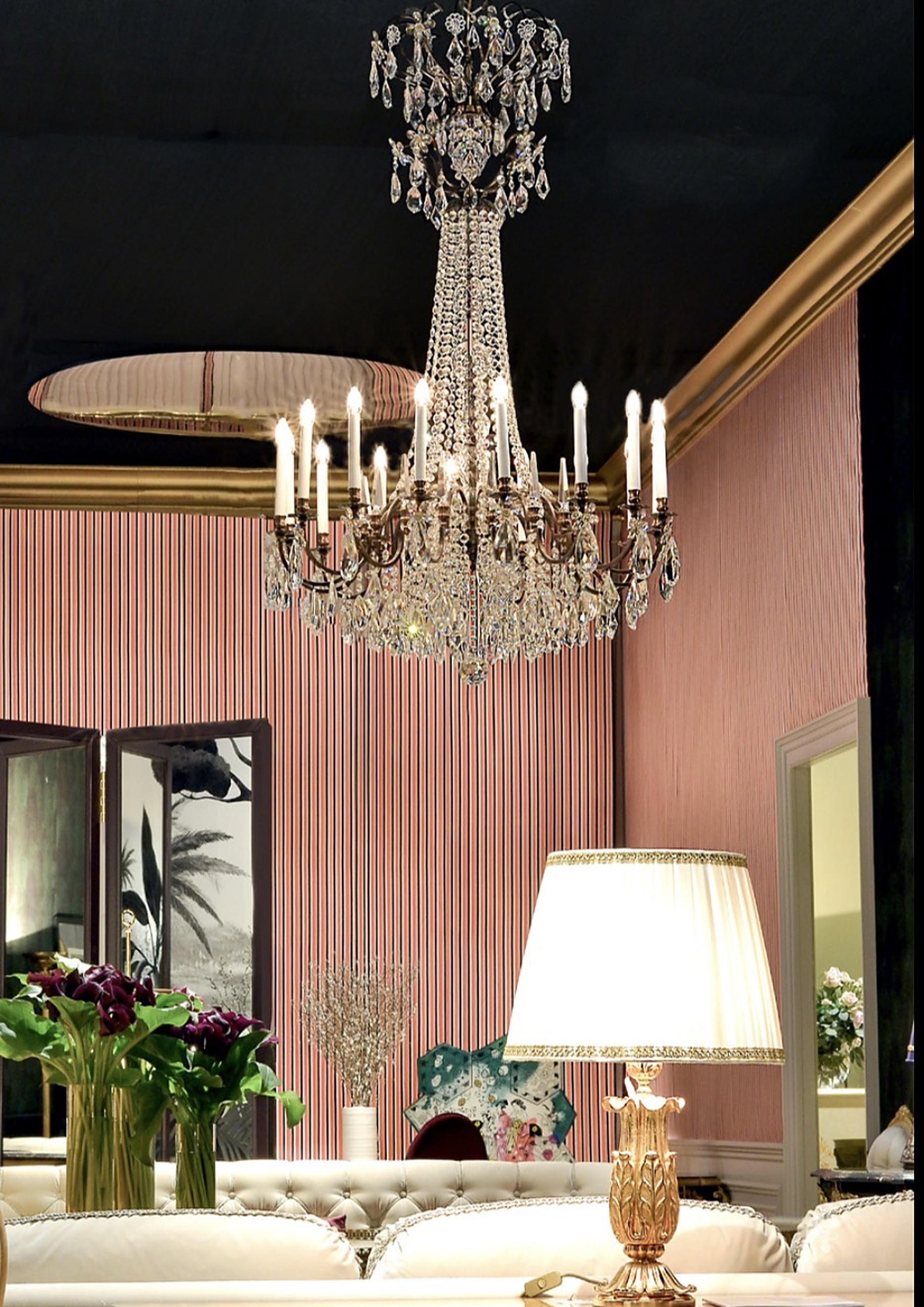 Crystal chandelier in a pink salon with gold table lamp — Magna Mercatus featured interior